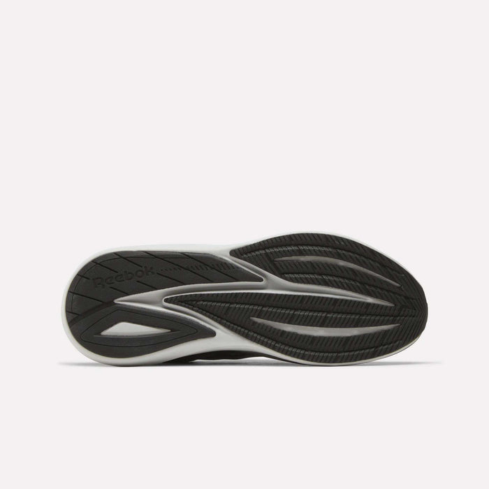 A black and white athletic shoe sole with a textured, wavy tread pattern and the Reebok logo visible on the left side. Designed for comfort, the Men’s Viva Speed Shoes by Reebok feature cushioned sneakers technology. The background is plain white.