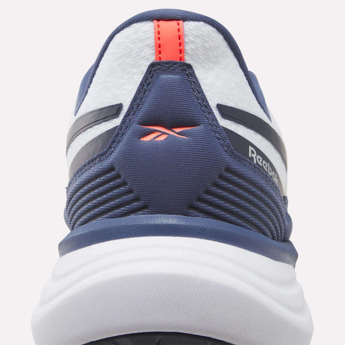 Close-up of the heel of a navy and white Reebok Men's Viva Speed Shoe, showcasing a red logo and red pull tab with textured and striped design details. These cushioned Men's Viva Speed Shoes provide both comfort and style.