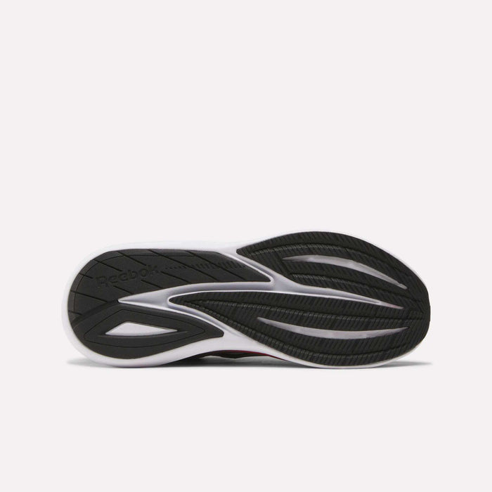 The image shows the black and white rubber outsole of Reebok Men's Viva Speed Shoes, laid flat to display the tread pattern and logo—engineered to pair seamlessly with the breathable mesh upper for comfort and performance.