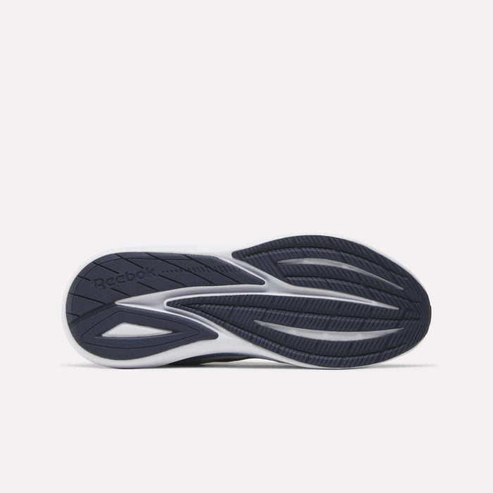 The image displays the black and white sole of a Men's Viva Speed Shoe by Reebok, viewed from the bottom, emphasizing its tread pattern and featuring the Reebok logo on the left side.