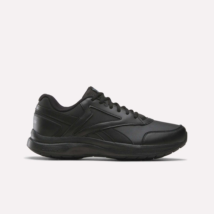 A side view of the Reebok Men's Walk Ultra 7 DMX Max Shoes - Wide 4E in Black/Cold Grey 5/Collegiate Royal is displayed on a plain white background, showcasing its lace-up design, low-cut profile, and textured sole with DMX cushioning for enhanced comfort.
