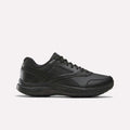 A side view of the Reebok Men's Walk Ultra 7 DMX Max Shoes - Wide 4E in Black/Cold Grey 5/Collegiate Royal is displayed on a plain white background, showcasing its lace-up design, low-cut profile, and textured sole with DMX cushioning for enhanced comfort.