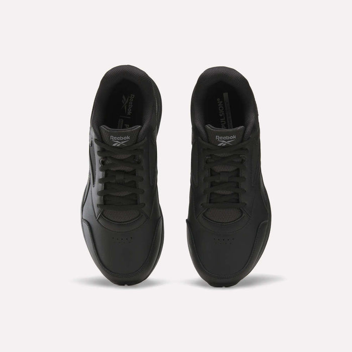 A pair of black Men's Walk Ultra 7 DMX Max Shoes - Wide 4E by Reebok is shown from above, highlighting the laces, toe area, and Reebok branding on the tongues, set against a plain white background. These wide-fit walking shoes are equipped with DMX cushioning for added comfort and support.
