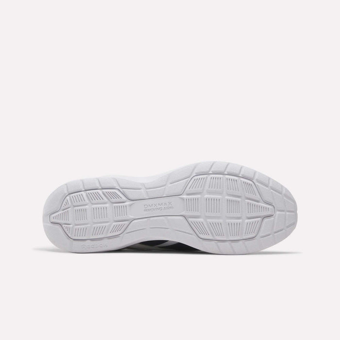 The image displays the white rubber outsole of the Men's Walk Ultra 7 DMX Max Shoes by Reebok, shown horizontally with textured grip patterns and "DMX MAX" stamped near the center, emphasizing the DMX cushioning technology featured in these comfortable walking shoes.