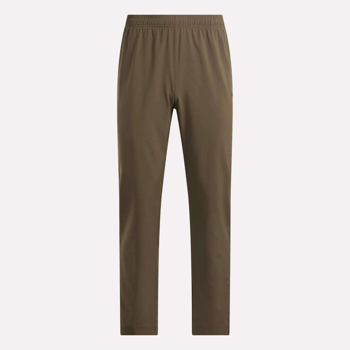 Reebok Men’s Woven Training Pants feature an elastic waistband and straight legs without visible pockets or extra detailing, shown against a plain light background—perfect for those looking for comfortable men’s workout pants.