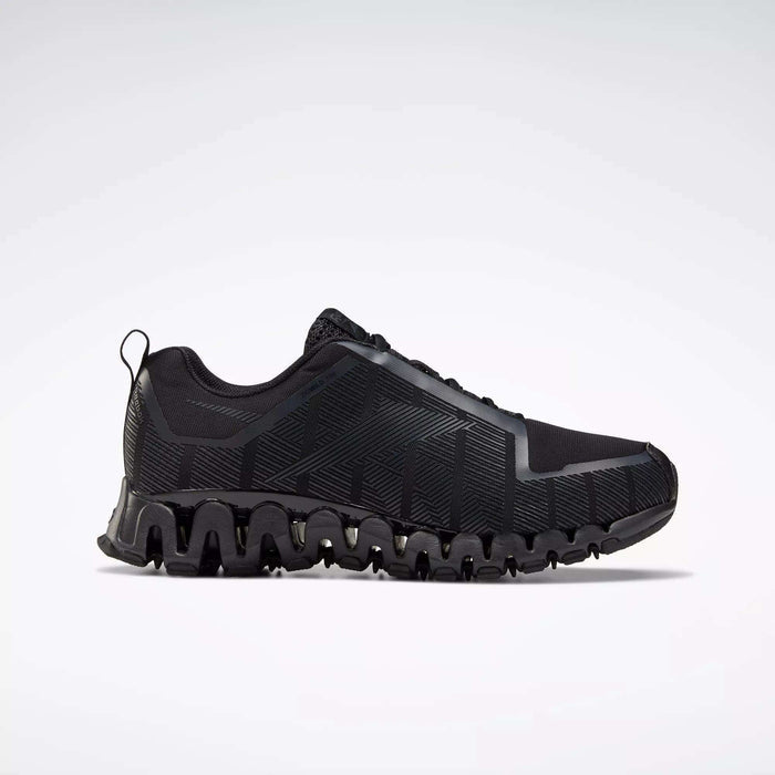 The Reebok Men's ZigWild Trail 6 Shoes, shown in profile against a white background, feature a black design with a textured geometric pattern and a thick wavy sole for enhanced cushioning.