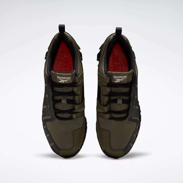 A pair of Reebok Men's ZigWild Trail 6 Shoes in olive green with black laces and soles, red interior lining, a black heel loop, mesh upper detailing, and enhanced cushioning for comfort is shown from above.
