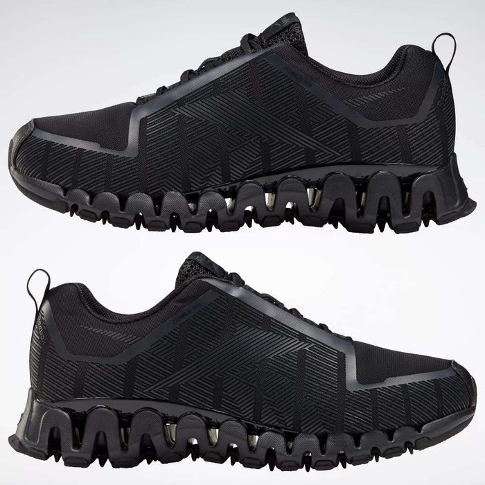 The Reebok Men's ZigWild Trail 6 Shoes in black feature geometric patterns and unique zigzag soles with enhanced cushioning, displayed in profile view against a plain light background.