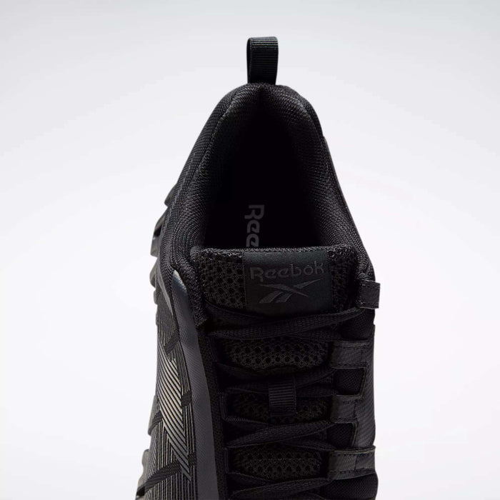 Top view of the Reebok Men's ZigWild Trail 6 Shoes in black, featuring a mesh and textured upper, laces, branded tongue, heel pull tab, and enhanced cushioning against a plain light background.
