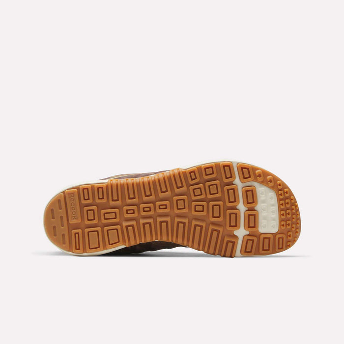 The image displays the bottom of a brown rubber sole from Reebok Nano 2.0 Training Shoes, highlighting a geometric tread pattern and a small white section near the toe.