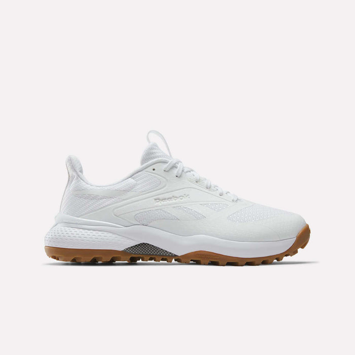 The Reebok Nano Golf Shoes feature a mesh and synthetic upper with lightweight FlexWeave, subtle Reebok branding, white laces, and a brown rubber sole. The white athletic sneakers are displayed against a plain white background.