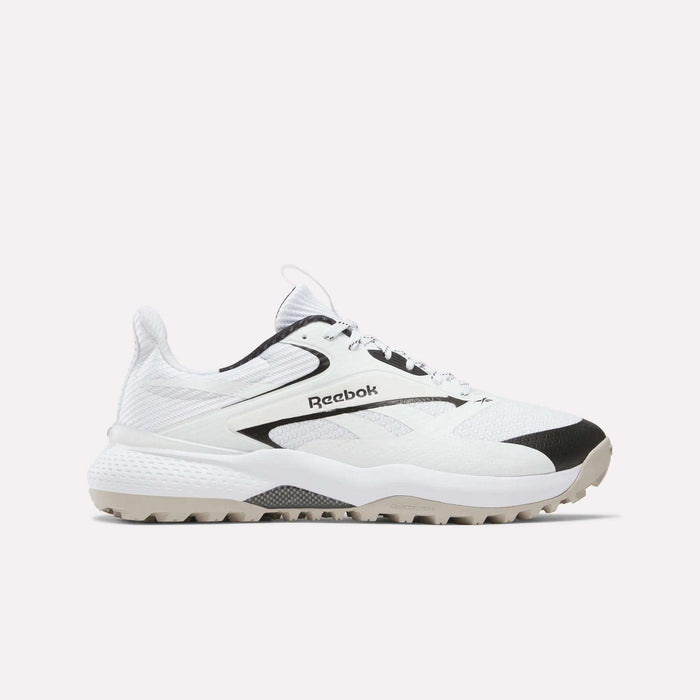 The Reebok Nano Golf Shoes are white with black accents, a textured sole, mesh panels, lace-up design, and FlexWeave upper. Shown from the side against a plain light background.