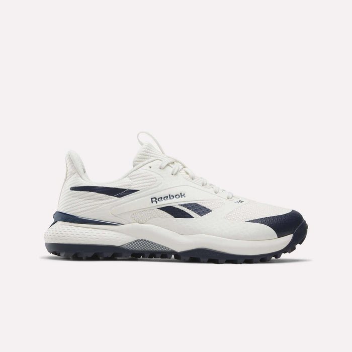 Navy and chalk Reebok Nano Golf Shoes featuring a mesh upper and Floatride foam for enhanced comfort, lace-up closure, branded side logo, and a textured rubber sole, displayed on a plain white background.