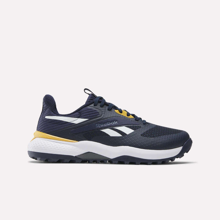 The Reebok Nano Golf Shoes in navy blue feature white and yellow accents, a lightweight FlexWeave upper, a white and black sole with Floatride foam, and the Reebok logo on the side, shown against a plain light background.