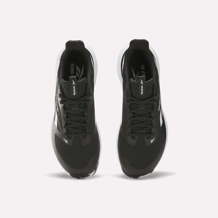 Top view of a pair of black Reebok Nano Golf Shoes with white soles, performance foam cushioning, and Reebok branding on the tongues and sides, positioned side by side on a white background.