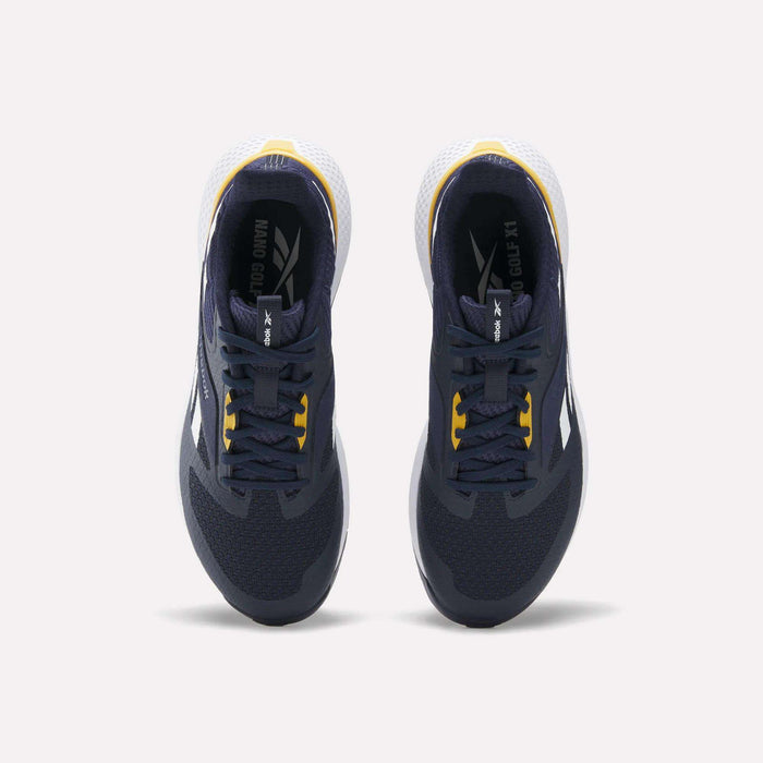 Top view of a pair of Reebok Nano Golf Shoes in dark navy with yellow accents, featuring a lightweight FlexWeave upper, white heel detail, and white outsole, placed side by side on a light background.