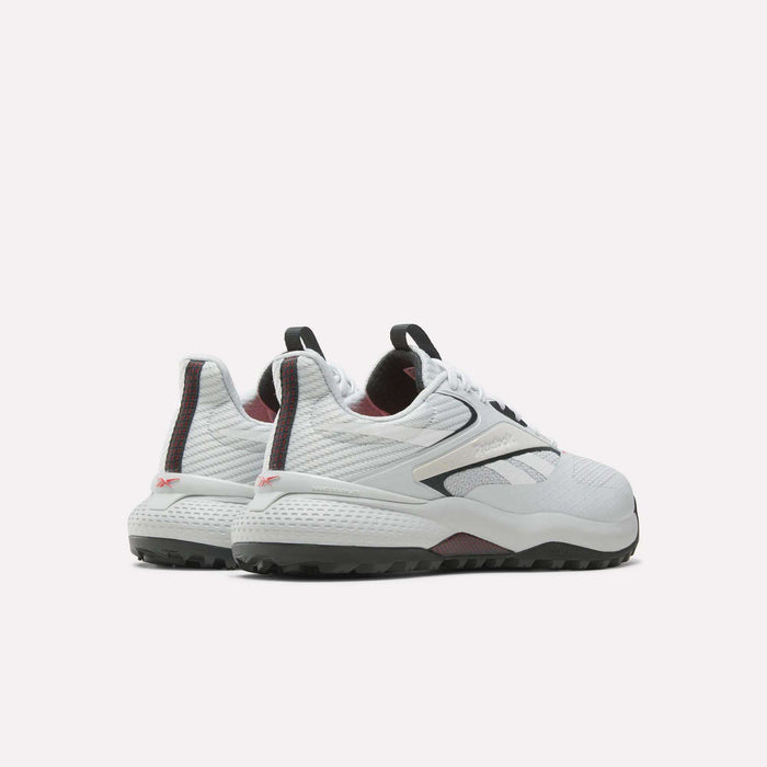 A pair of Reebok Nano Golf Shoes in white, featuring black and maroon accents, shown from the back and side with textured soles and a lightweight mesh FlexWeave upper on a plain white background.
