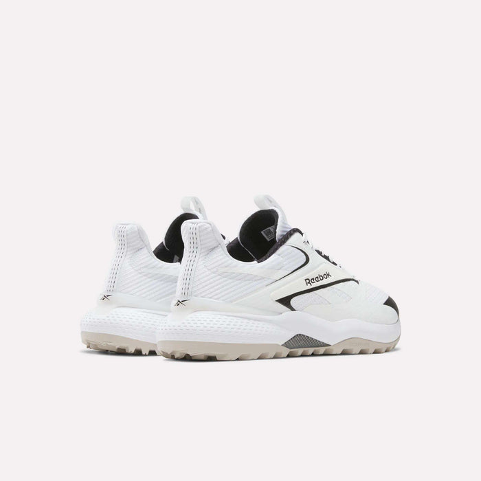 A pair of Reebok Nano Golf Shoes with chunky soles and black accents, featuring a FlexWeave upper, is angled to display the sides and backs against a plain white background.
