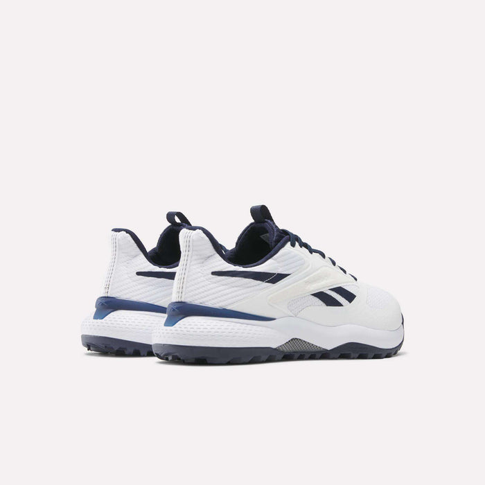 A pair of Reebok Nano Golf Shoes in white with navy accents and black soles, featuring a lightweight FlexWeave upper, shown from the back and side against a plain light background.