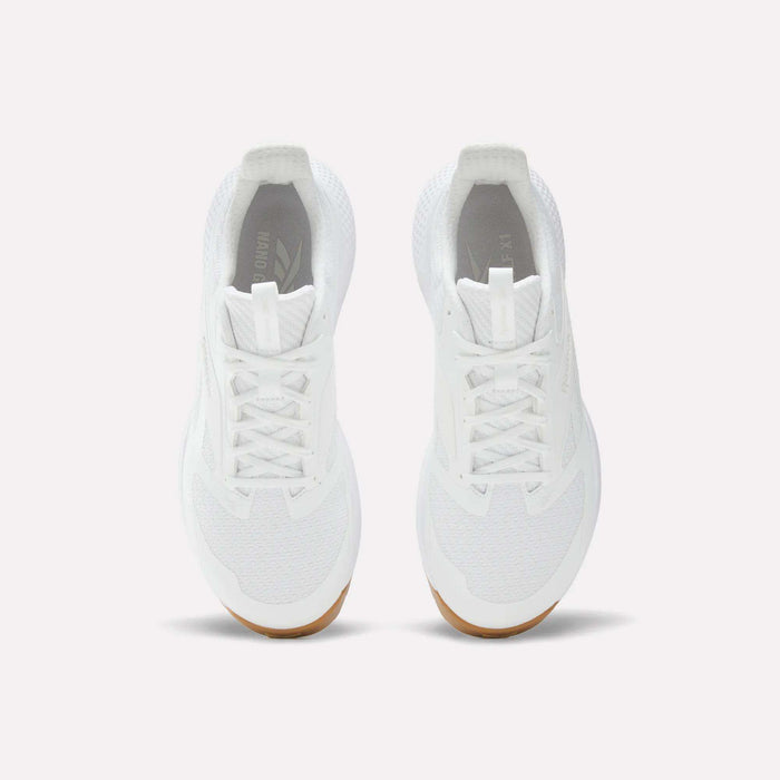 A pair of Reebok Nano Golf Shoes in white, featuring white laces, mesh details, and lightweight FlexWeave for breathability. Tan-colored outsoles appear at the toe. Shown from above on a plain white background.