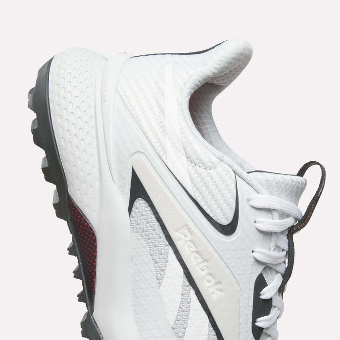 Reebok Nano Golf Shoes with a lightweight FlexWeave upper, black accents, and a rugged traction sole. Features textured details and is shown from the side against a plain light background.