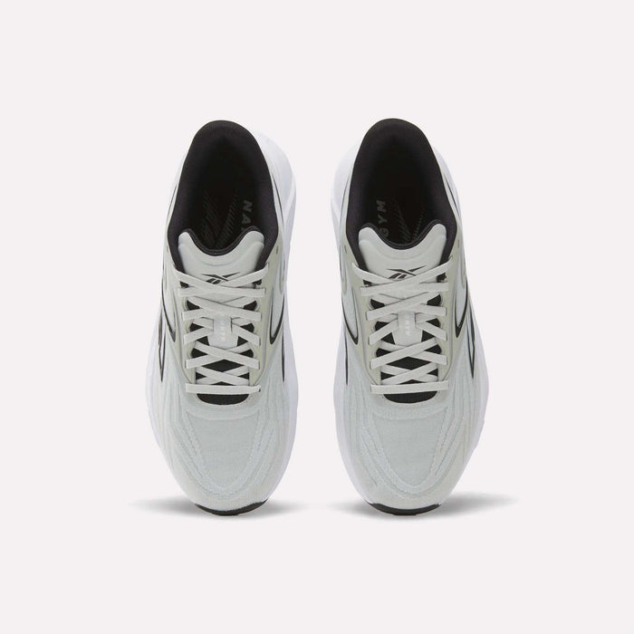A top view of Reebok Nano Gym 2.0 Training Shoes shows a white pair with black accents, white laces, a slightly chunky silhouette, and a comfortable black interior.