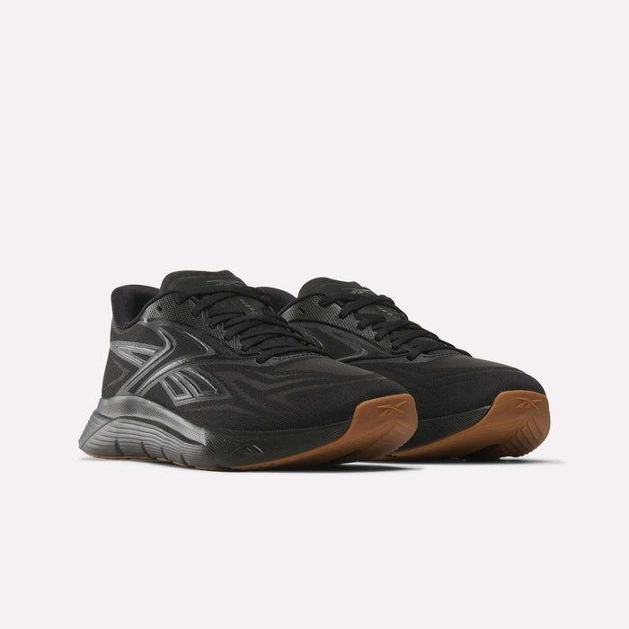 The Reebok Nano Gym 2.0 Training Shoes in black feature sleek silver accents, brown rubber soles, and high-rebound foam, displayed on a plain white background.