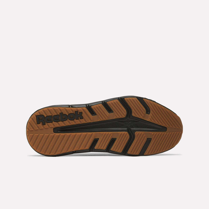 The image shows the sole of a Reebok Nano Gym 2.0 Training Shoe with a brown and black rubber tread, the Reebok logo near the heel, and angled grooves designed for grip and traction—ideal for versatile training sessions.