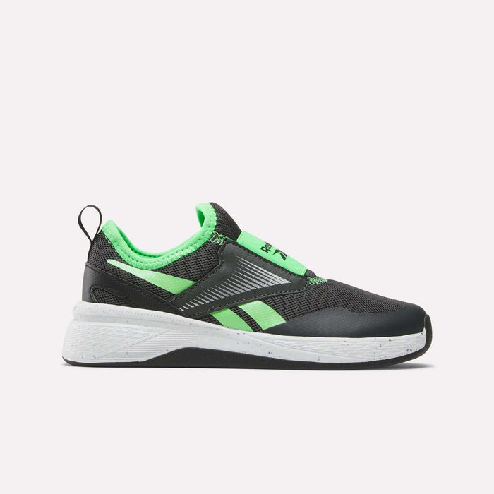 The Reebok Nano Play Slip-On Shoes for little kids feature a black design with neon green accents, white speckled sole, heel pull tab, and diagonal green stripes—ideal for active children seeking stylish comfort inspired by Nano trainer tech.
