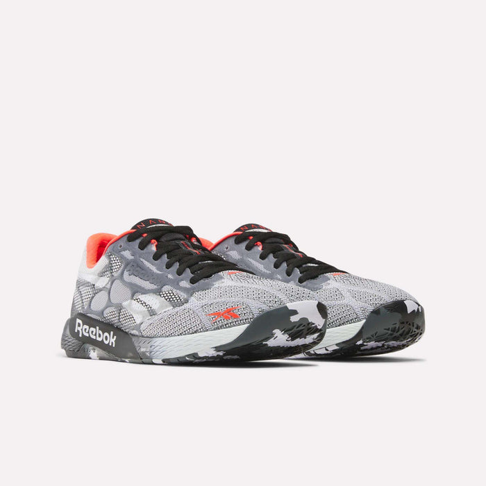 The Reebok Nano Pro Training Shoes feature a gray mesh upper, black laces, white and black patterned soles, red accents, and visible Reebok logos—ideal for competitive athletes.