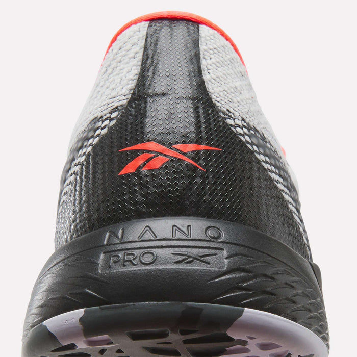 Close-up of the back of gray and black Reebok Nano Pro Training Shoes with red accents, featuring the Reebok logo and "NANO PRO" text on the heel—designed for competitive athletes.