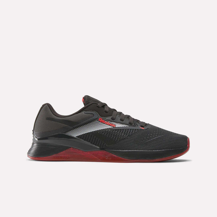The Reebok Nano X4 Training Shoes feature a black design with red sole and accents, white and silver side stripes, black laces, and a textured upper. These low-cut sneakers are ideal for gym sessions or active wear.