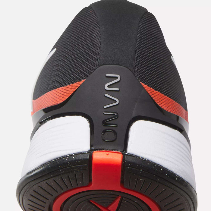 Close-up of the heel on the black Reebok Nano X4 Training Shoes, featuring red and white accents. The word NOVA is embossed on a black heel support, and the outsole displays a circular tread pattern.