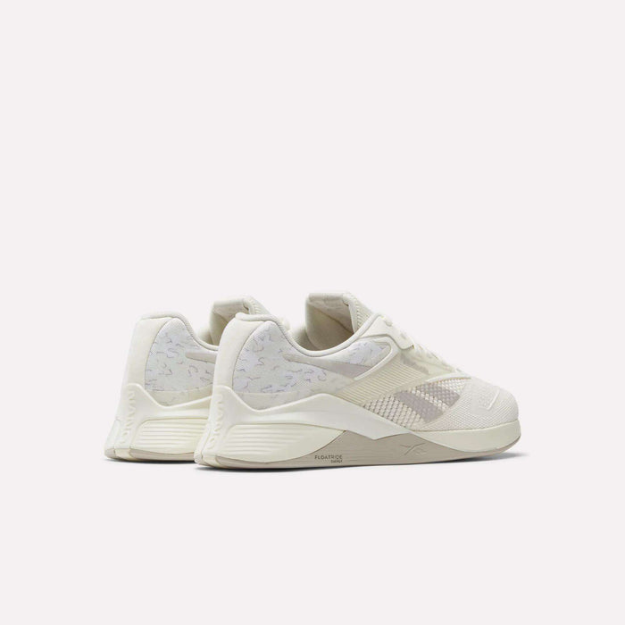 A pair of Reebok Nano X4 Training Shoes in off-white with light grey accents and textured details, displayed from a rear side angle on a plain white background.