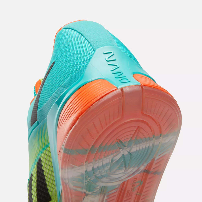 Close-up of Reebok Nano X4 Training Shoes featuring a turquoise heel with "NANO" embossed, an orange and translucent rubber sole, and a bright blue and yellow-green breathable mesh upper.