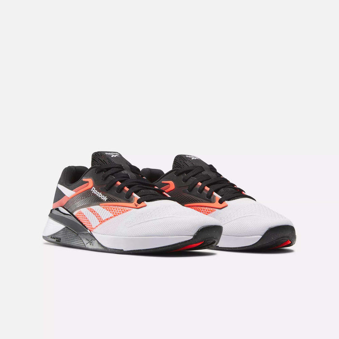 A pair of Reebok Nano X4 Training Shoes featuring white mesh uppers, black and coral accents, black soles, and red details are shown on a plain white background, angled slightly to the right.