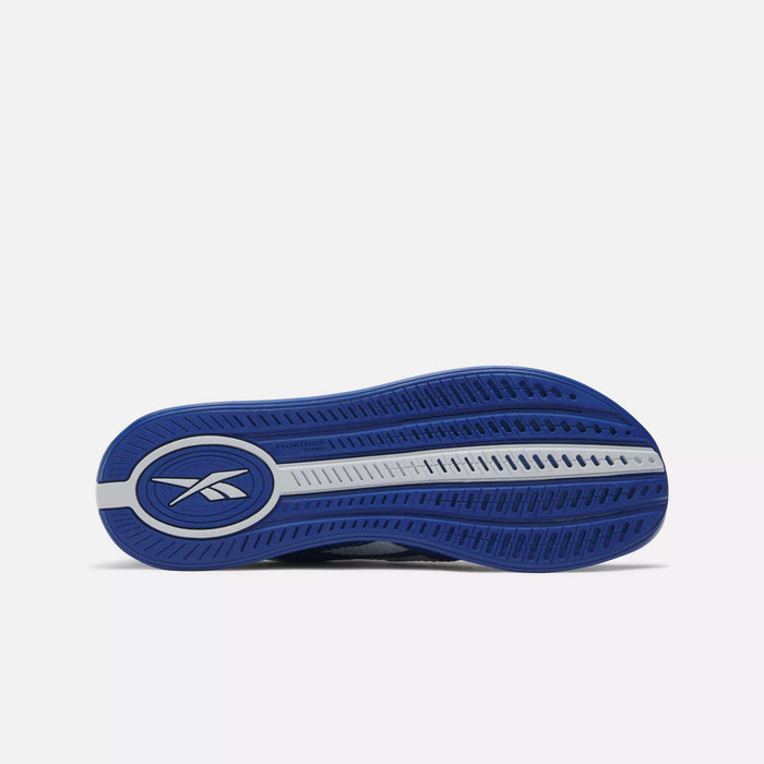 The image shows the blue and gray sole of Reebok Nano X4 Training Shoes, featuring the Reebok logo and a patterned tread for grip and flexibility, set against a plain white background.