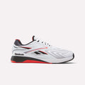 A white Reebok athletic shoe with red and black accents, featuring a low-cut design, mesh upper, and the Reebok logo on the heel and side.