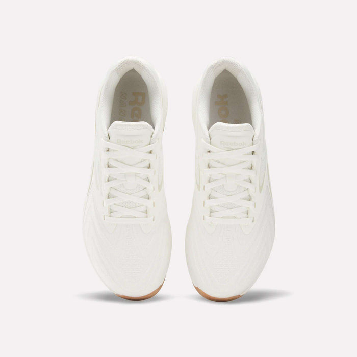 Top view of Reebok Nano X5 Edge Training Shoes in all-white with white laces and gum soles, placed side by side on a plain light background, designed for peak performance.