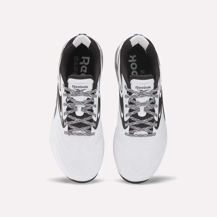 Top view of Reebok Nano X5 Edge Training Shoes in white with black accents, black-and-white laces, and visible Reebok logos on the insoles and tongue, set against a plain white background.
