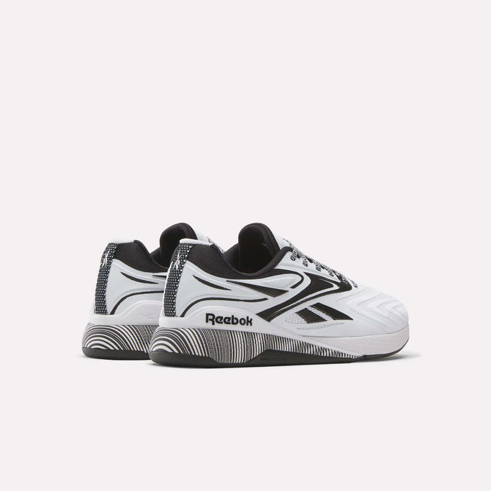 A pair of Reebok Nano X5 Edge Training Shoes in white and black, featuring graphic patterns on the soles and sides, are displayed on a plain white background. Designed for peak athletic performance.