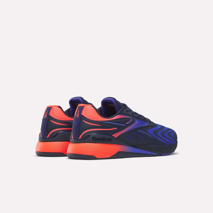 A pair of Reebok Nano X5 Edge Training Shoes, featuring a navy blue Flexweave upper with red-orange accents on the heel, side, and sole—precision trainers shown on a plain white background.