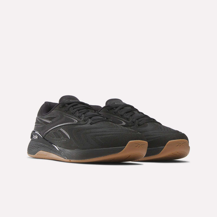 A pair of black Reebok Nano X5 Edge Training Shoes with Flexweave mesh uppers, black laces, silver accents, and light brown rubber soles displayed on a white background—ideal for precision training.