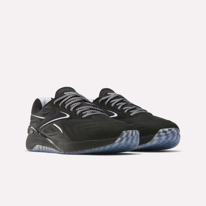 A pair of Reebok Nano X5 Edge Training Shoes in black with white and gray accents, featuring patterned laces and translucent gray soles, displayed against a plain light background—engineered by Reebok for peak performance inside and outside the gym.