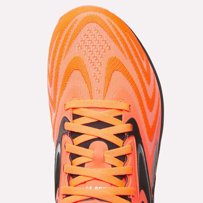 Close-up of the upper part of Reebok Nano X5 Edge Training Shoes in bright orange with matching laces and black accents, showcasing a textured mesh surface engineered for top performance.