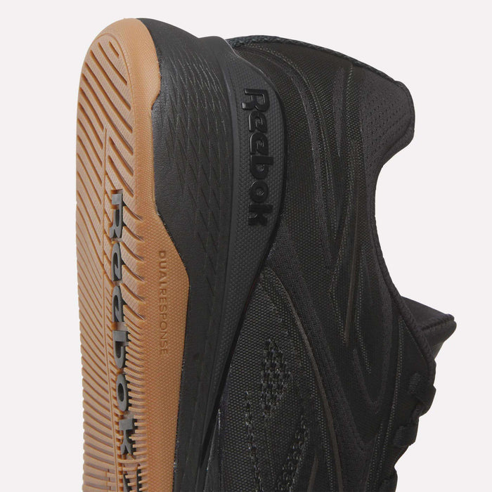 Close-up of Reebok Nano X5 Edge Training Shoes with a black Flexweave mesh upper, side logo, tan rubber sole, and visible Dual Response label.