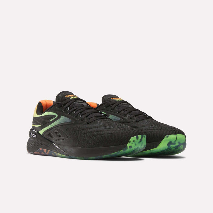 A pair of Reebok Nano X5 Edge Training Shoes in black with green accents, orange inner lining, and a green-patterned Flexweave sole are displayed against a plain white background.