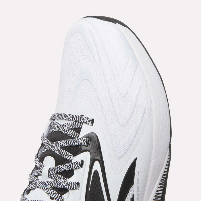 Close-up of the front and side of Reebok Nano X5 Edge Training Shoes, showing black accents, a wavy textured pattern, black-and-white laces, and part of the sole designed for optimal performance.