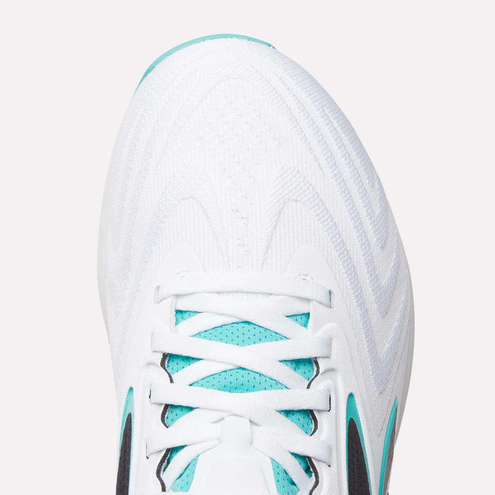 Close-up of the toe and laces of Reebok Nano X5 Edge Training Shoes—a white athletic shoe with light blue accents and black details, featuring a textured pattern—perfect for workout and precision training enthusiasts.