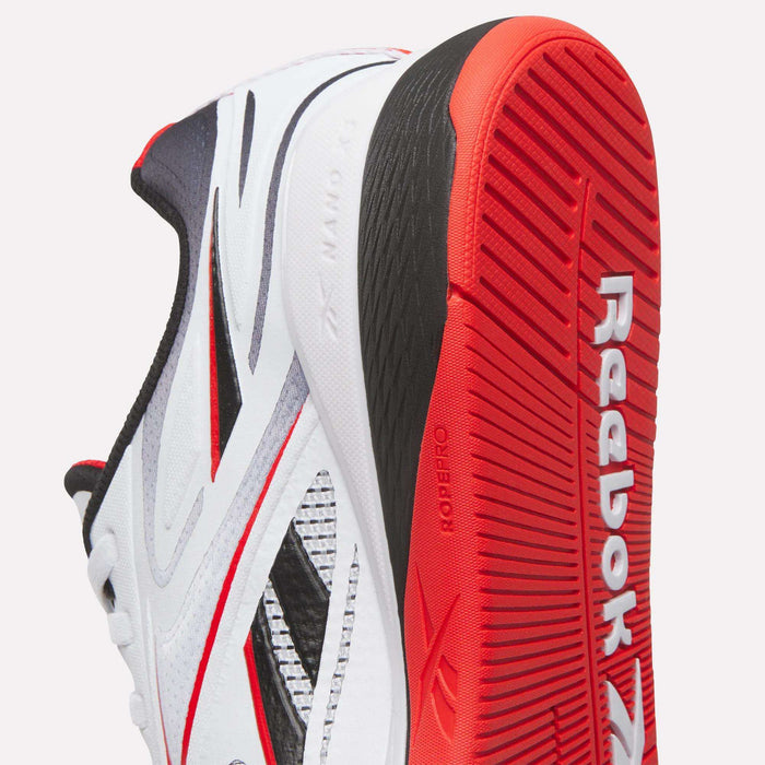 Close-up of Reebok Nano X5 Edge Training Shoes in white, black, and red, showcasing Flexweave side details and a textured red outsole with the Reebok logo embossed on the bottom.